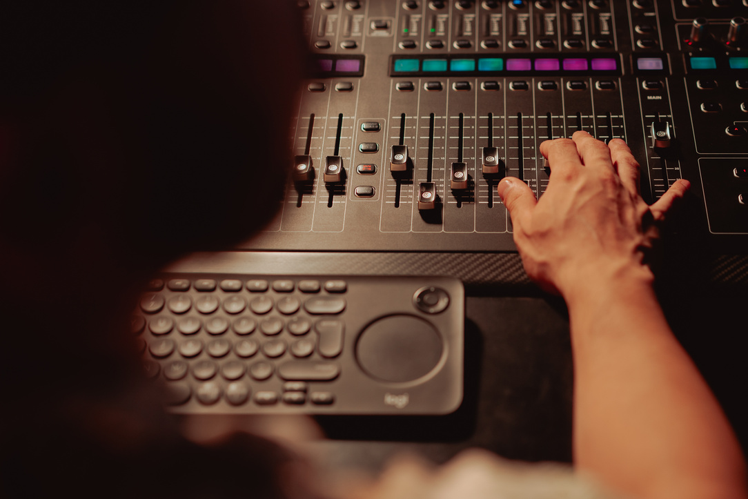 A Sound Engineer Controlling the Audio Mixer